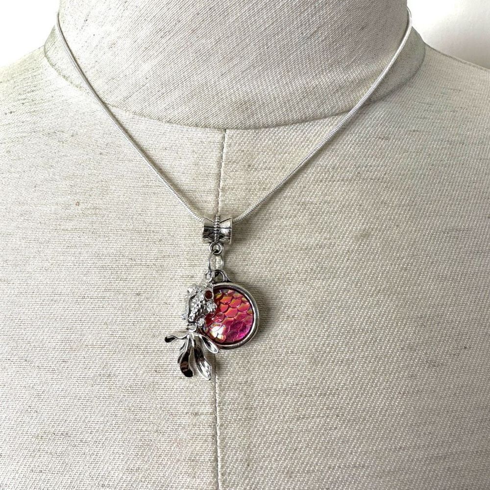 Silver tone fish pink disc charm necklace